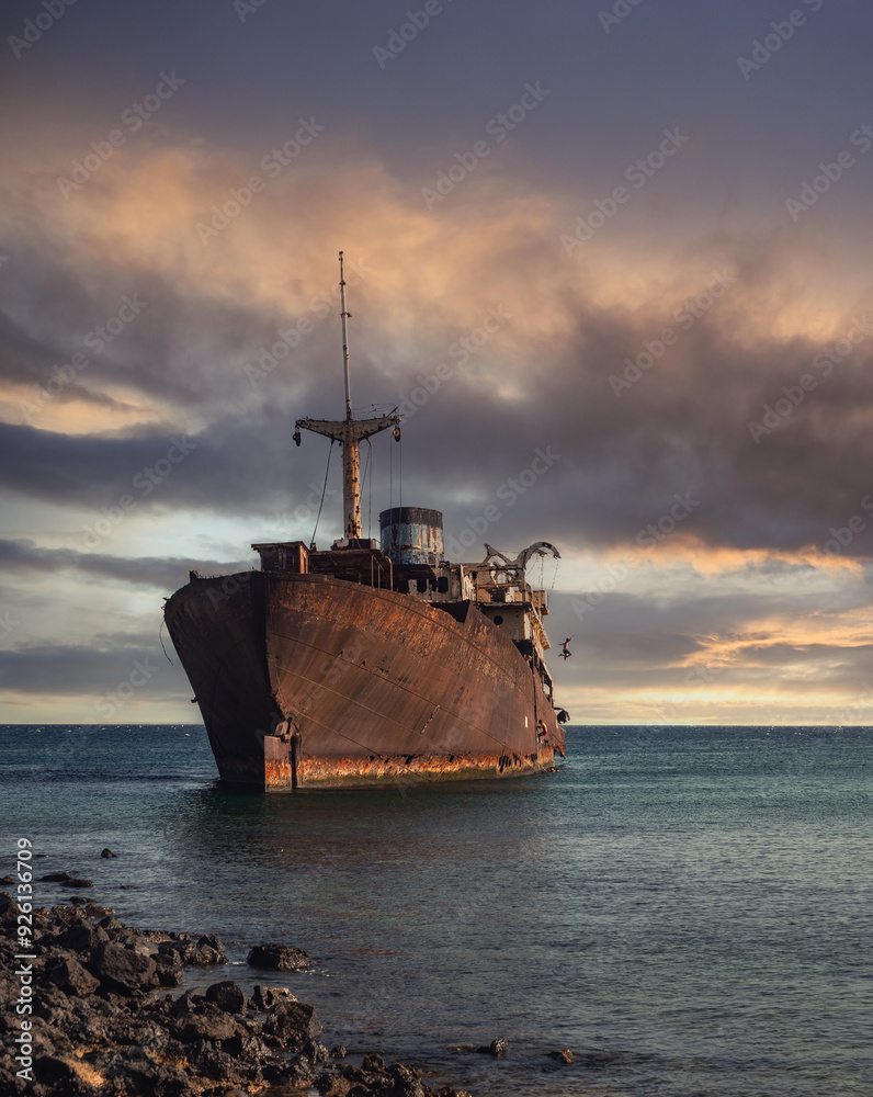 Fototapeta premium Young teenager jumping overboard from shipwreck