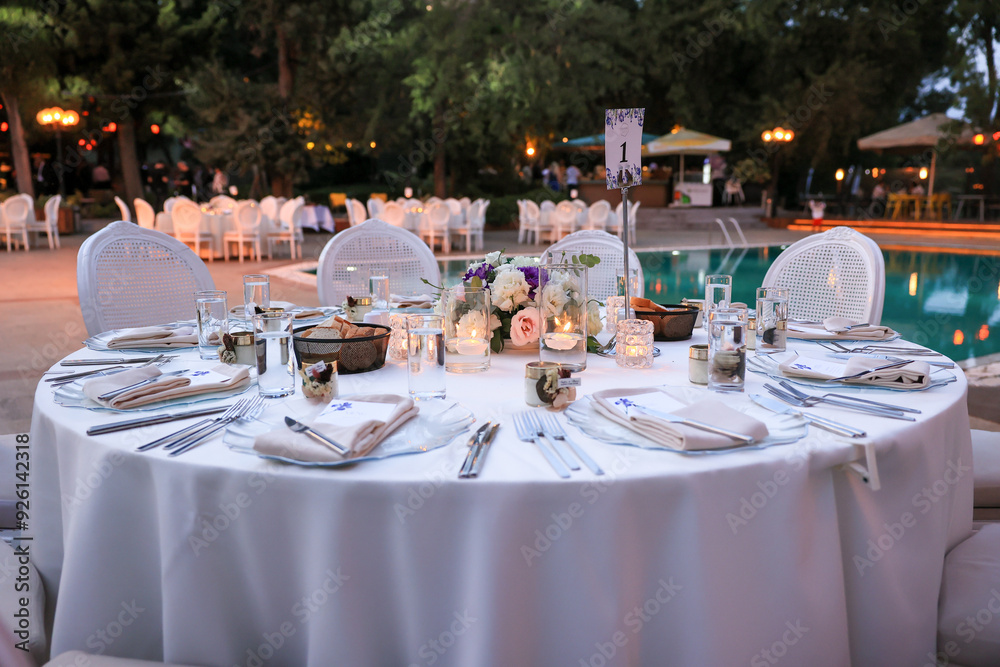 Elegant Poolside Wedding Reception with Round Tables and White Chairs
