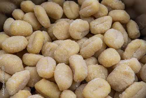 Close-up of freshly gnocchi, showcasing soft, pillowy texture and golden-brown edges. Perfectly captured detail of Italian dumplings. photo