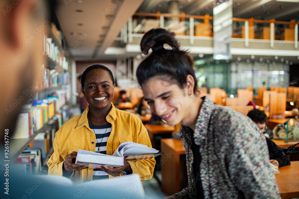 Diverse students picking books in college library Diverse students picking books in college library