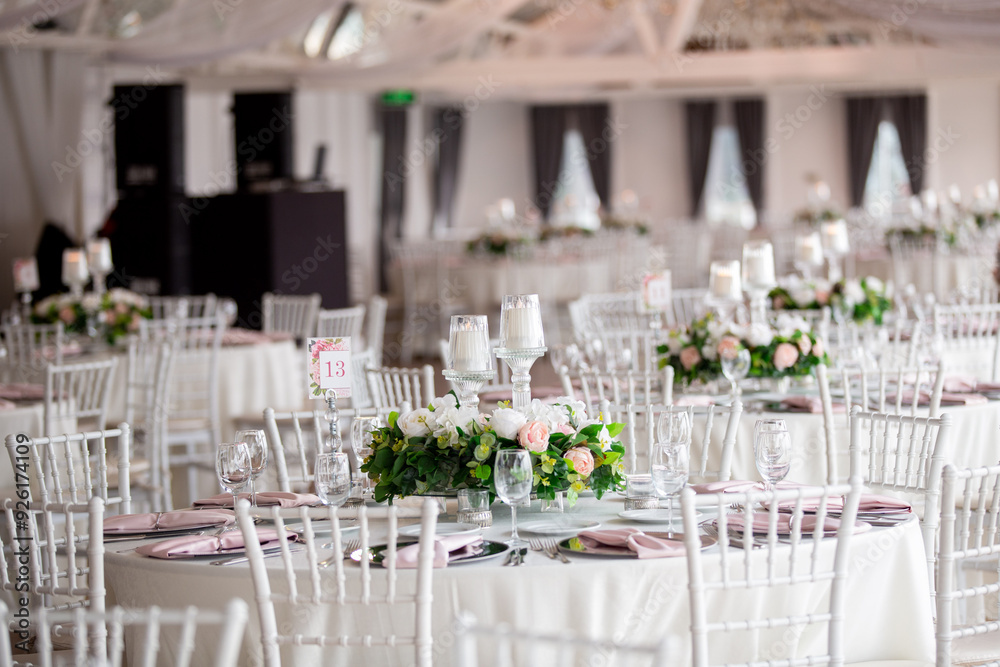 Elegant Wedding Venue with Floral Arrangements and Crystal Chairs