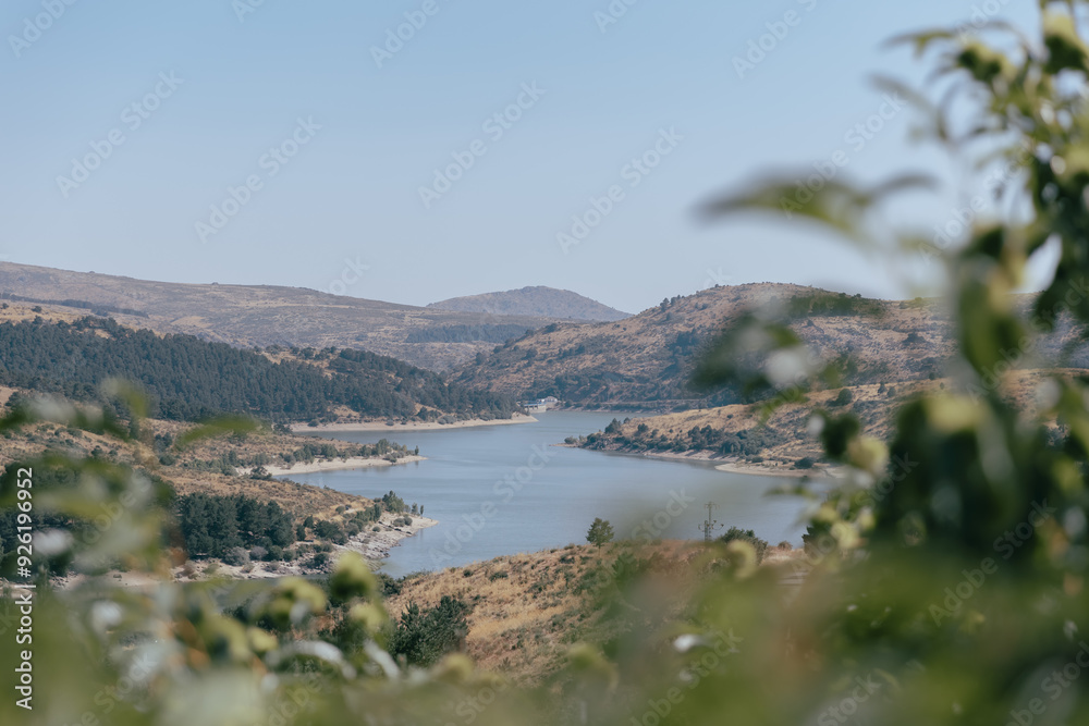 View from the hill to the lake and mountains in the background. View from the hill to the lake and mountains in the background.