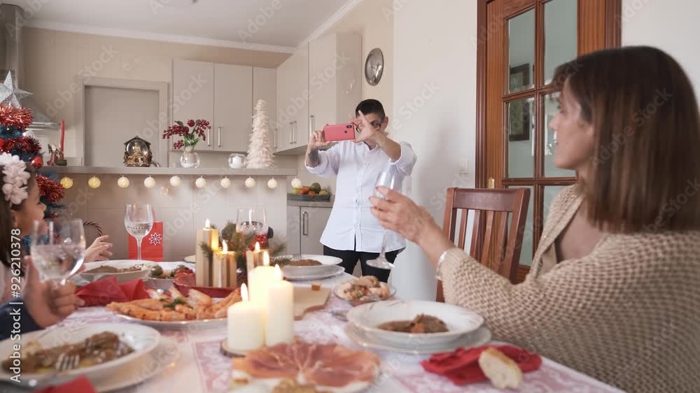 Mother taking a picture during Christmas lunch Mother taking a picture during Christmas lunch