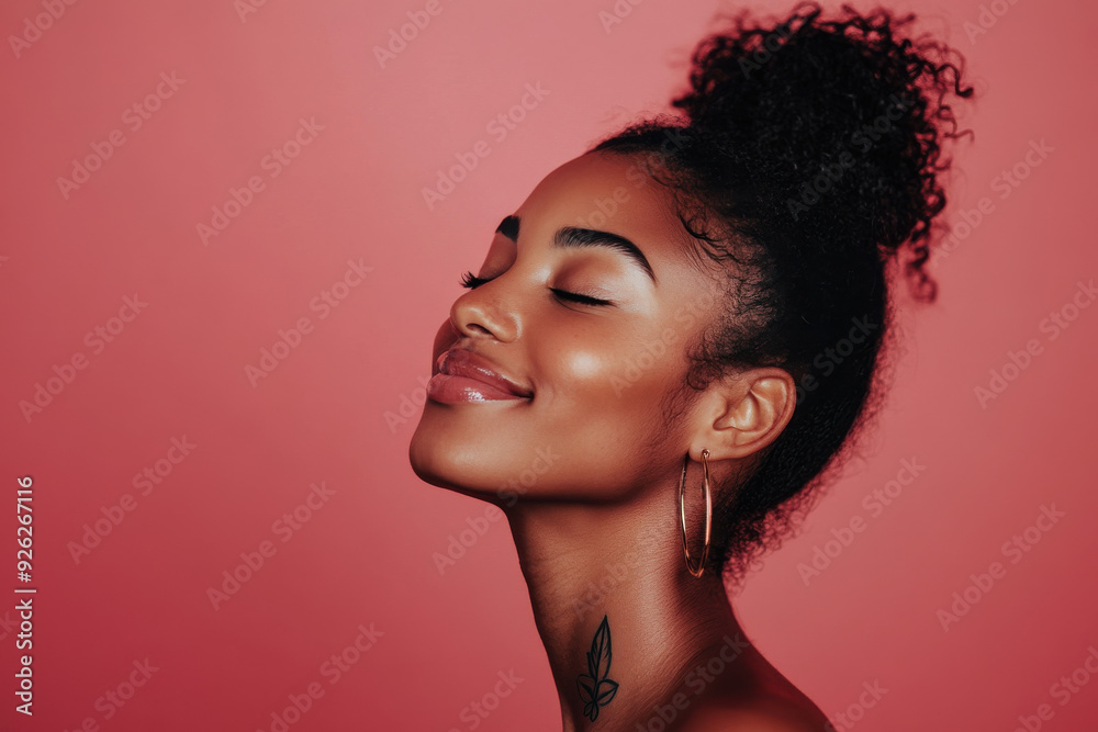 A close up of a tattooed black woman's face with her eyes closed A close up of a tattooed black woman's face with her eyes closed