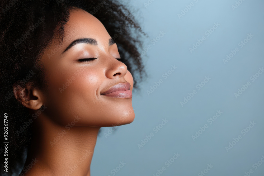 A close up of a tattooed black woman's face with her eyes closed A close up of a tattooed black woman's face with her eyes closed