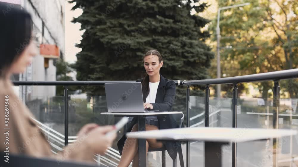 Young woman working on her laptop at a rooftop workspace with a relaxing view. Perfect for showcasing remote work, digital nomad lifestyle, and productivity in a serene setting. Young woman working on her laptop at a rooftop workspace with a relaxing view. Perfect for showcasing remote work, digital nomad lifestyle, and productivity in a serene setting.