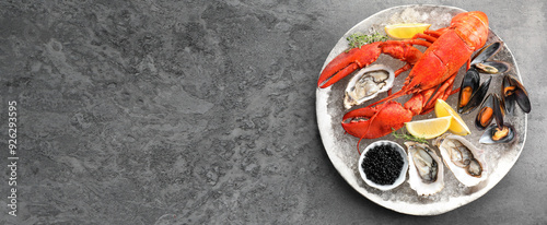 Many different fresh sea food on grey table, flat lay. Banner design with space for text photo