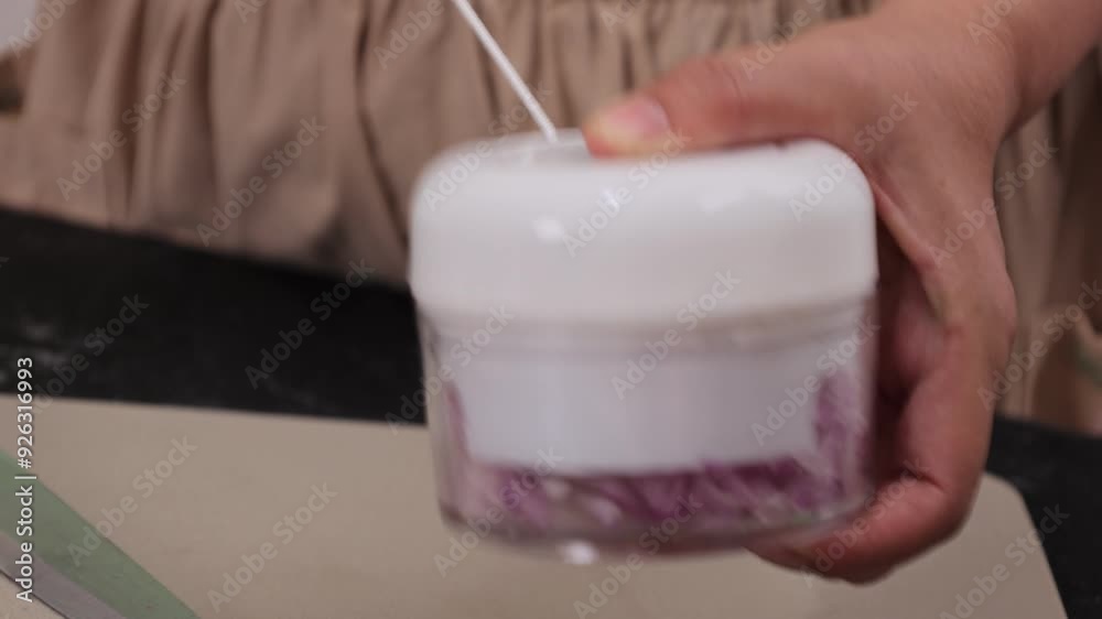 Female Hand Chopping Garlic and Shallots using Manual Grinder Female Hand Chopping Garlic and Shallots using Manual Grinder