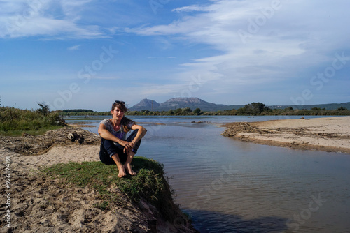 Girl and dog on the shore of the river delta, river Ter, Costa Brava, Catalonia, Spain