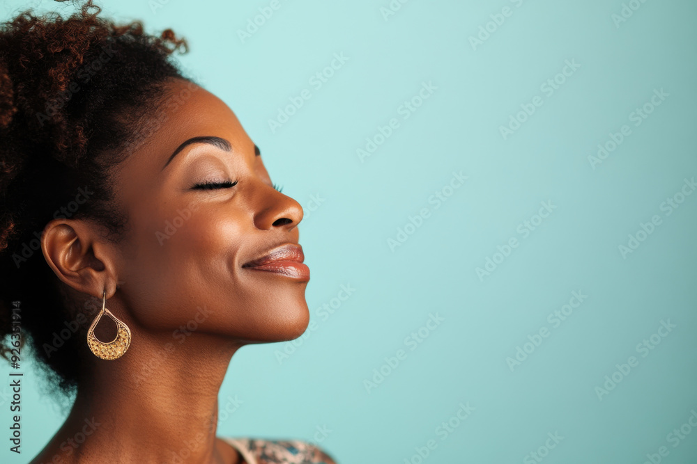 A close up of a tattooed black woman's face with her eyes closed A close up of a tattooed black woman's face with her eyes closed