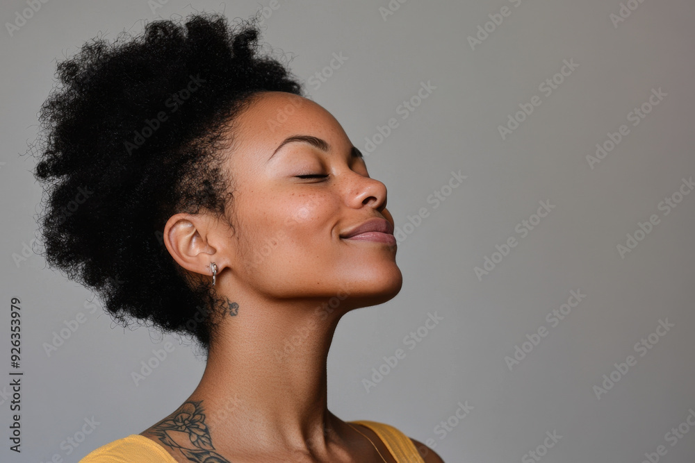 A close up of a tattooed black woman's face with her eyes closed A close up of a tattooed black woman's face with her eyes closed