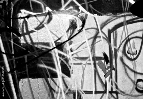 Abstract spray painting graffiti wall background. Random stroke line with spray. Rustic and grunge texture urban. Agitate, disturb and annoy. Black and white colors. Close up.