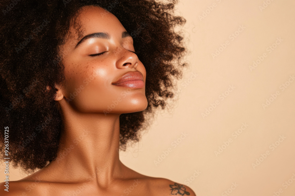 A close up of a tattooed black woman's face with her eyes closed A close up of a tattooed black woman's face with her eyes closed