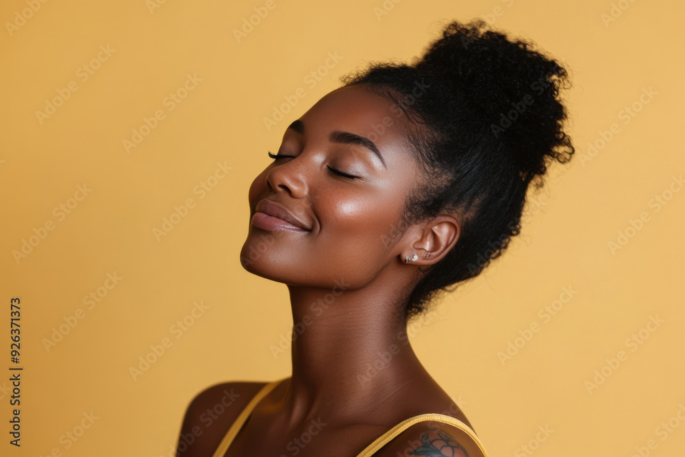 A close up of a tattooed black woman's face with her eyes closed A close up of a tattooed black woman's face with her eyes closed