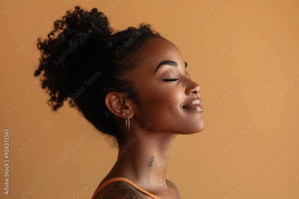 A close up of a tattooed black woman's face with her eyes closed A close up of a tattooed black woman's face with her eyes closed