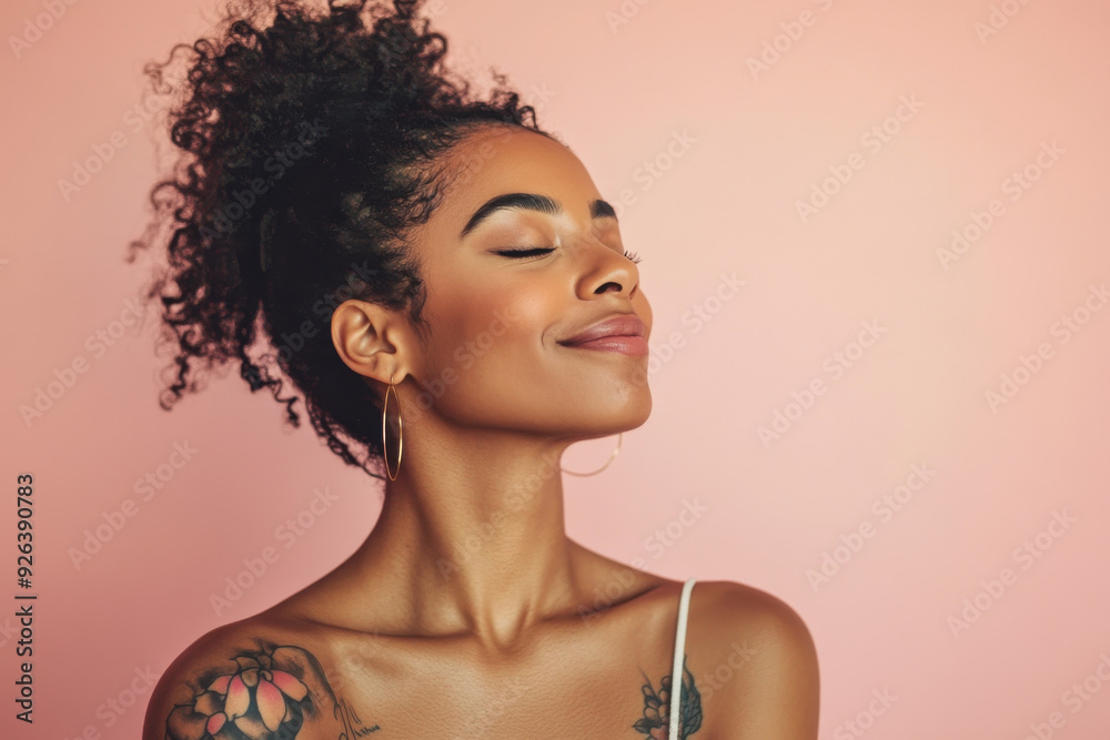 A close up of a tattooed black woman's face with her eyes closed A close up of a tattooed black woman's face with her eyes closed