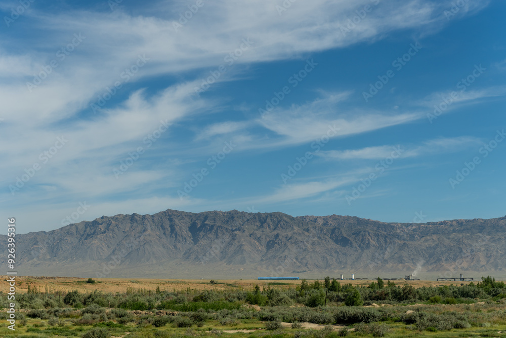 Fototapeta premium Majestic Mountains and Lush Fields in Xinjiang