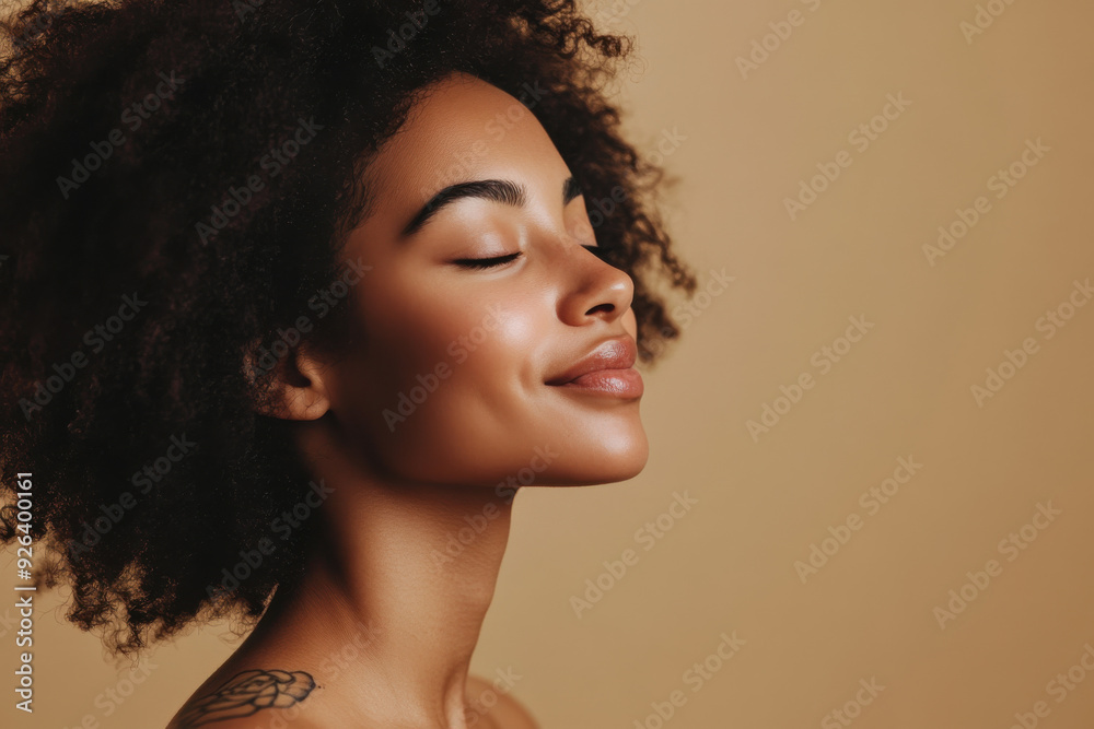 A close up of a tattooed black woman's face with her eyes closed A close up of a tattooed black woman's face with her eyes closed