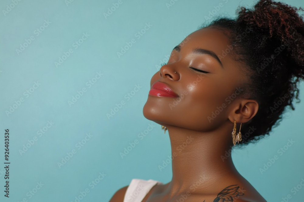 A close up of a tattooed black woman's face with her eyes closed A close up of a tattooed black woman's face with her eyes closed