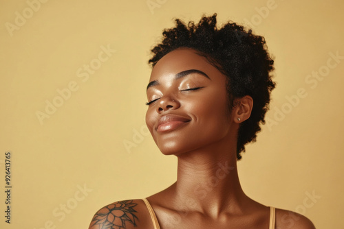 A close up of a tattooed black woman's face with her eyes closed