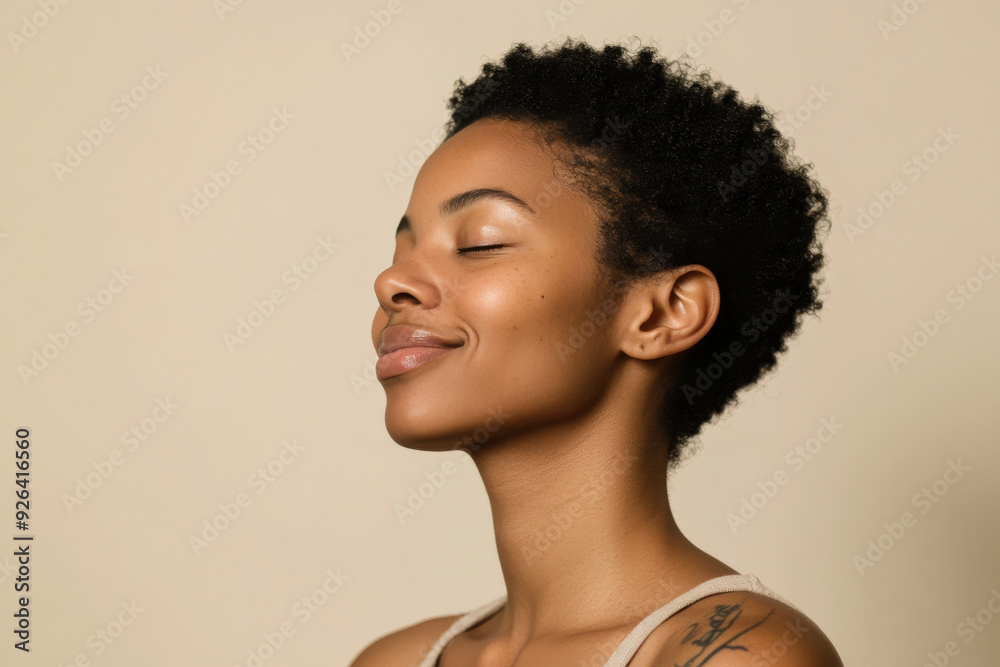 A close up of a tattooed black woman's face with her eyes closed A close up of a tattooed black woman's face with her eyes closed