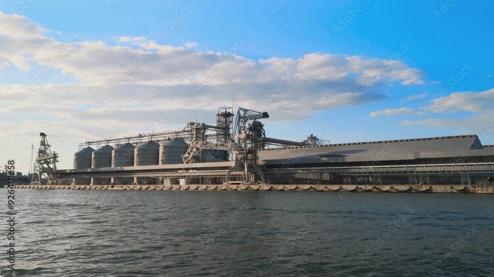Color footage of a grain storage terminal in a sea port. 