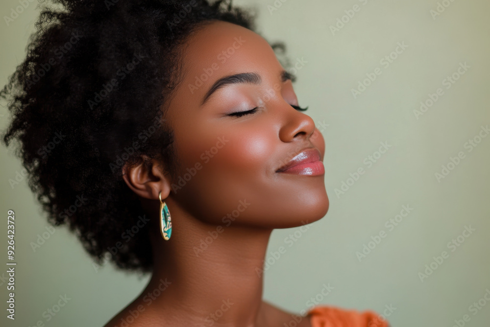 A close up of a tattooed black woman's face with her eyes closed A close up of a tattooed black woman's face with her eyes closed