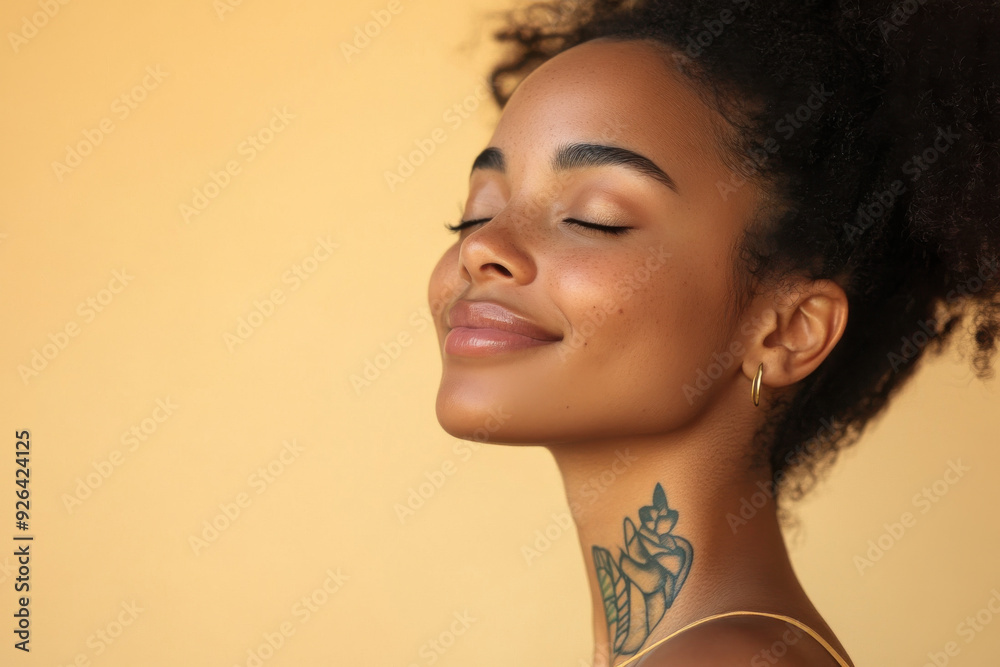 A close up of a tattooed black woman's face with her eyes closed A close up of a tattooed black woman's face with her eyes closed