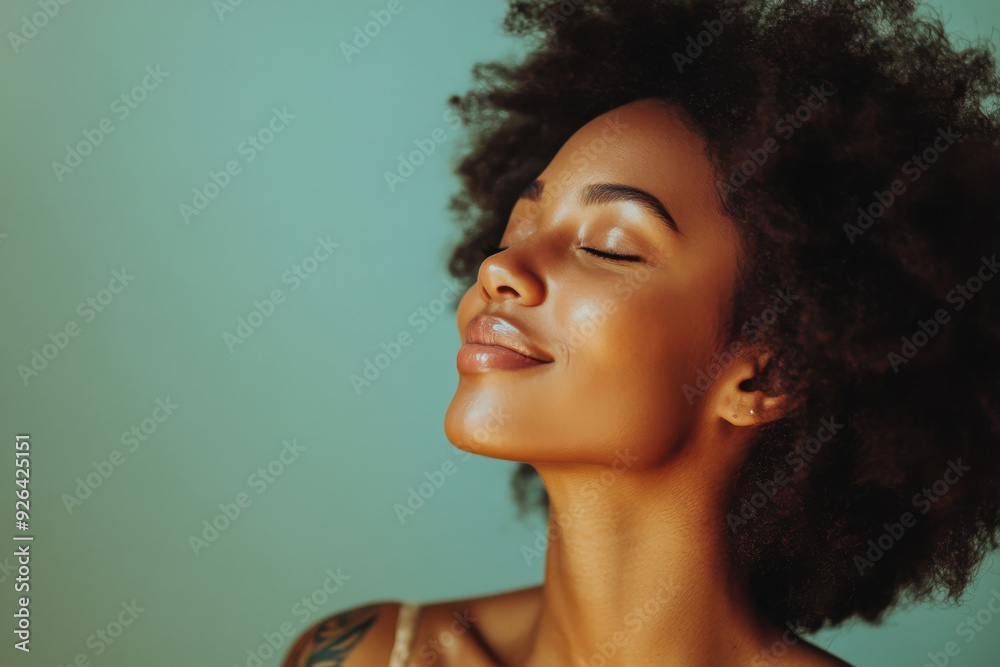 A close up of a tattooed black woman's face with her eyes closed A close up of a tattooed black woman's face with her eyes closed
