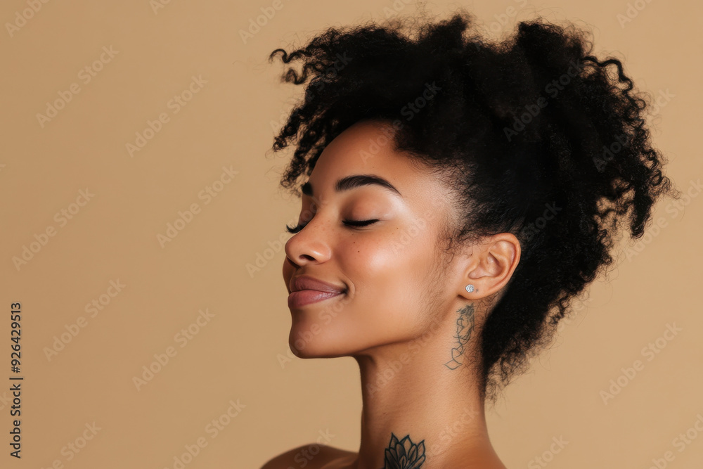 A close up of a tattooed black woman's face with her eyes closed A close up of a tattooed black woman's face with her eyes closed
