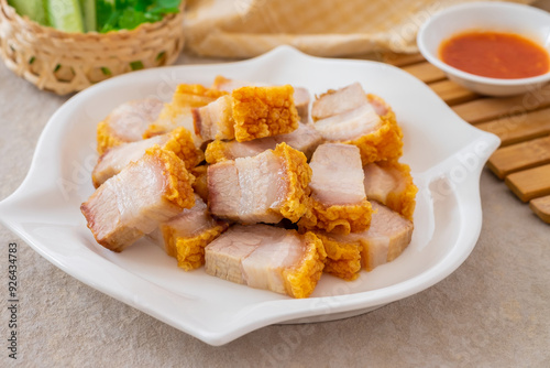 Crispy pork belly on white plate and dipping sauce