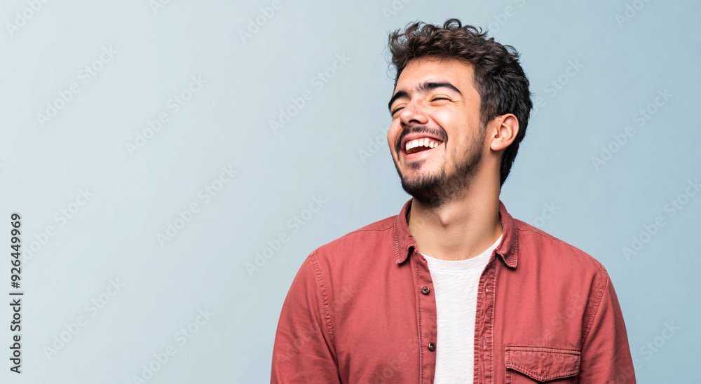 Obraz premium A happy adult Hispanic man looking away with a confident smile on his face.