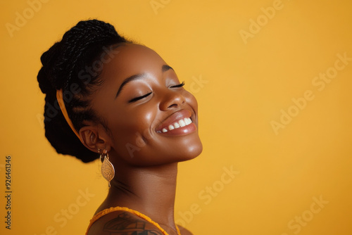 A close up of a tattooed black woman's face with her eyes closed