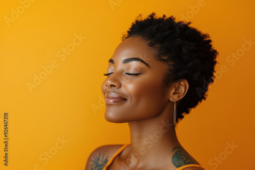 A close up of a tattooed black woman's face with her eyes closed