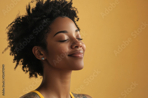 A close up of a tattooed black woman's face with her eyes closed