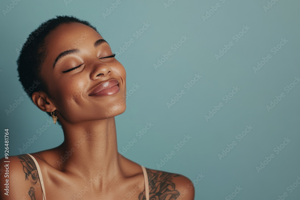 A close up of a tattooed black woman's face with her eyes closed
