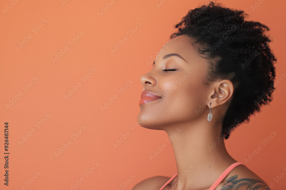 A close up of a tattooed black woman's face with her eyes closed A close up of a tattooed black woman's face with her eyes closed