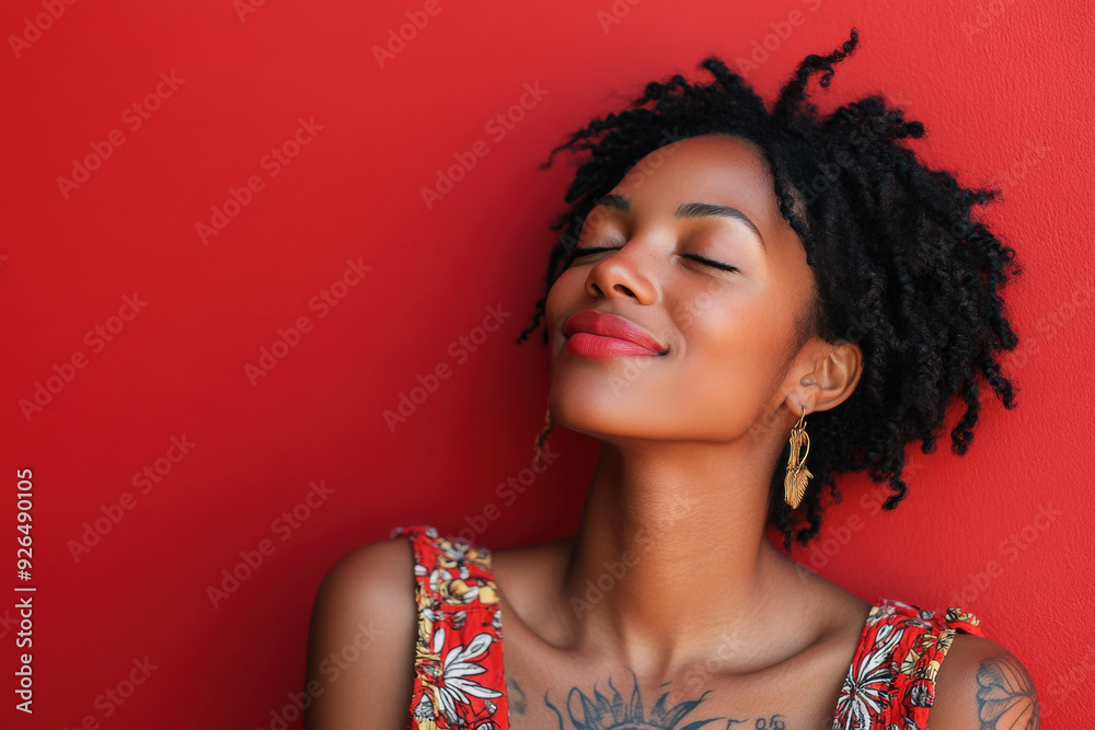 A close up of a tattooed black woman's face with her eyes closed A close up of a tattooed black woman's face with her eyes closed