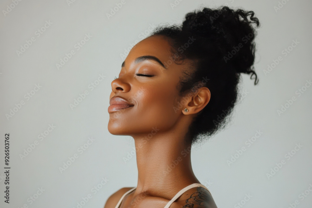 A close up of a tattooed black woman's face with her eyes closed A close up of a tattooed black woman's face with her eyes closed