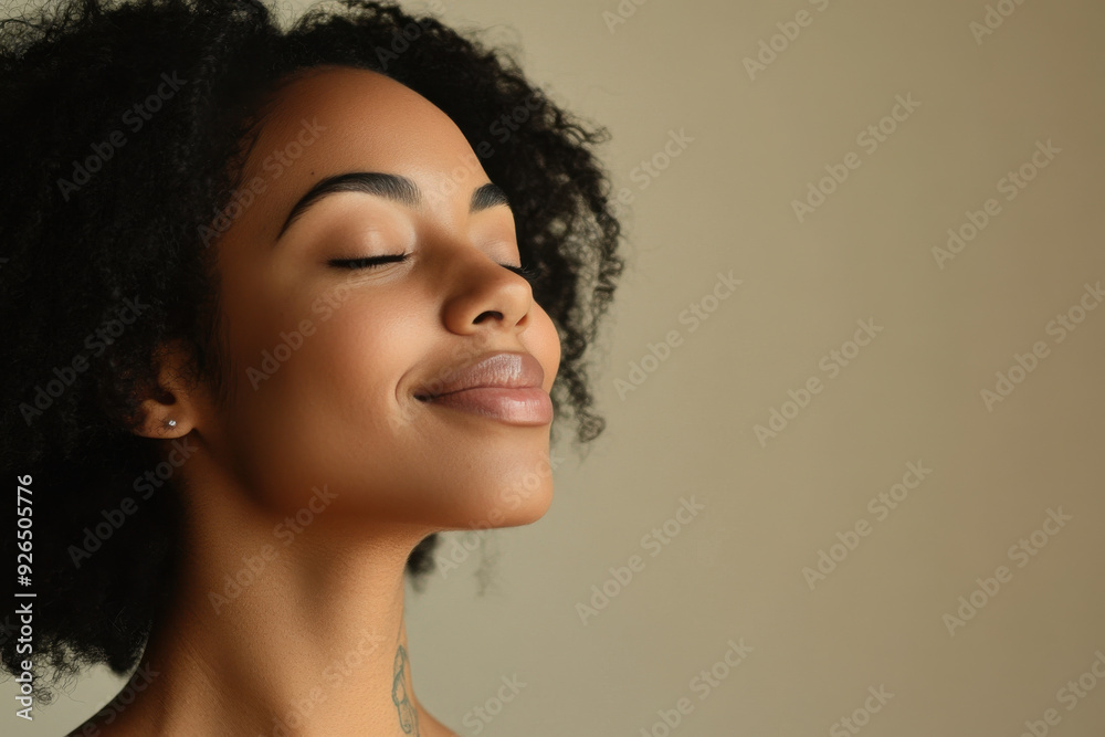 A close up of a tattooed black woman's face with her eyes closed A close up of a tattooed black woman's face with her eyes closed