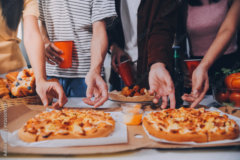 Group of young friends eating pizza.Home party. Group of young friends eating pizza.Home party.