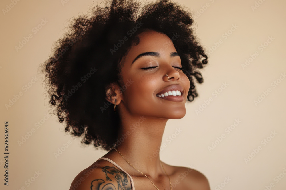 A close up of a tattooed black woman's face with her eyes closed