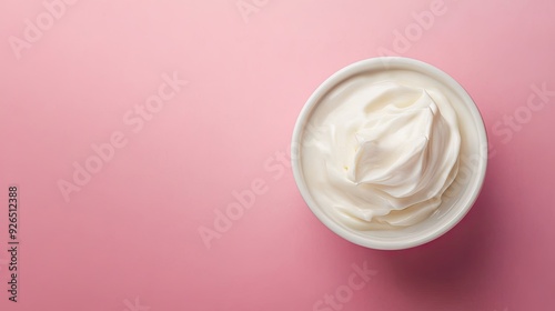 A white bowl filled with creamy yogurt isolated on a solid pastel background, with space for text on the side.