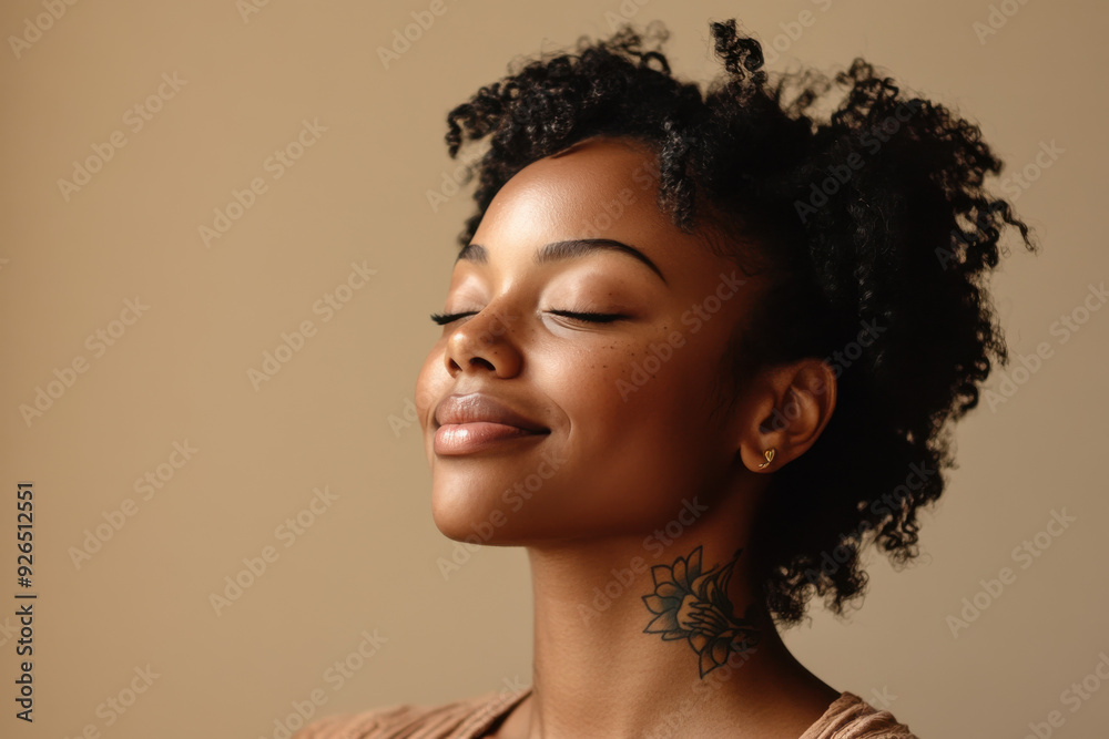 A close up of a tattooed black woman's face with her eyes closed A close up of a tattooed black woman's face with her eyes closed