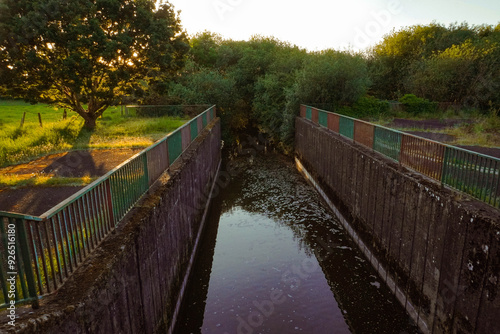 Wastewater treatment facilities and sewage systems surrounded by natural landscapes, blending industrial infrastructure with the environment photo