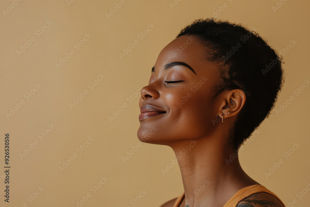 A close up of a tattooed black woman's face with her eyes closed A close up of a tattooed black woman's face with her eyes closed