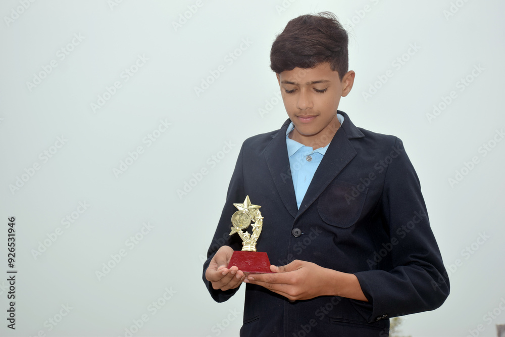 Indian handsome school boy with gold medal, school concept, selective focus Indian handsome school boy with gold medal, school concept, selective focus
