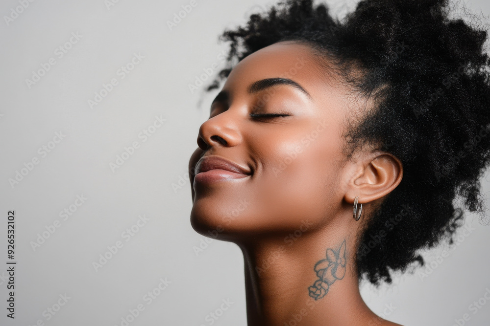 A close up of a tattooed black woman's face with her eyes closed A close up of a tattooed black woman's face with her eyes closed