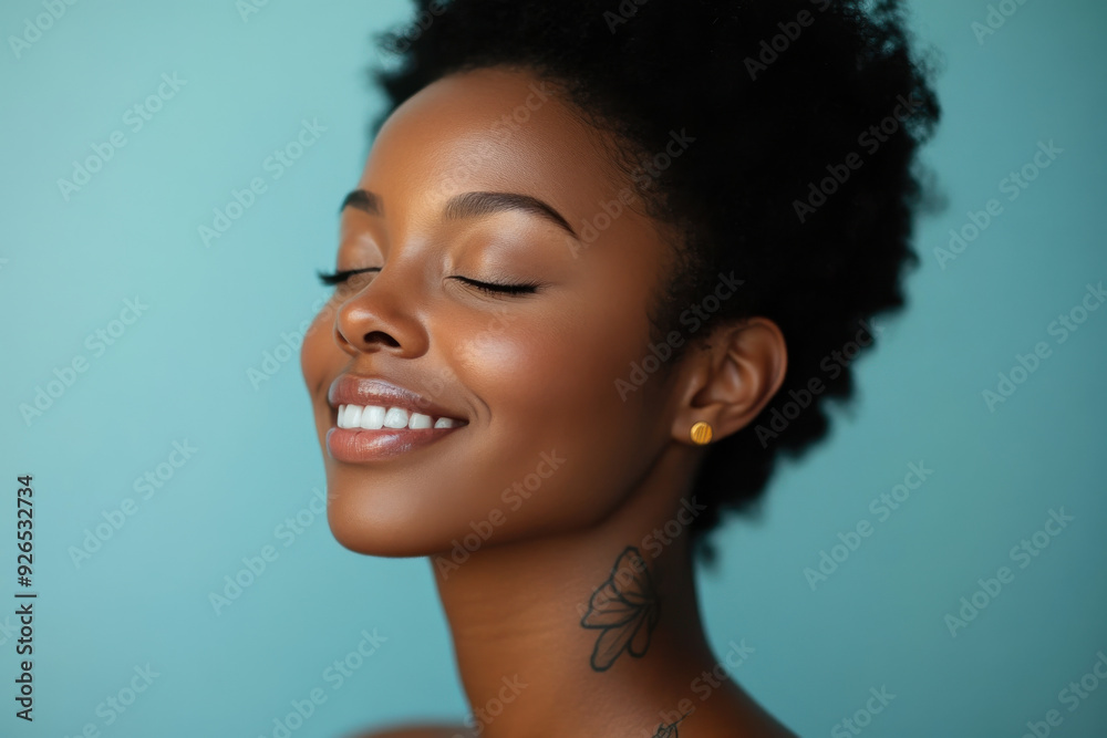 A close up of a tattooed black woman's face with her eyes closed A close up of a tattooed black woman's face with her eyes closed