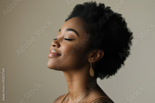 A close up of a tattooed black woman's face with her eyes closed